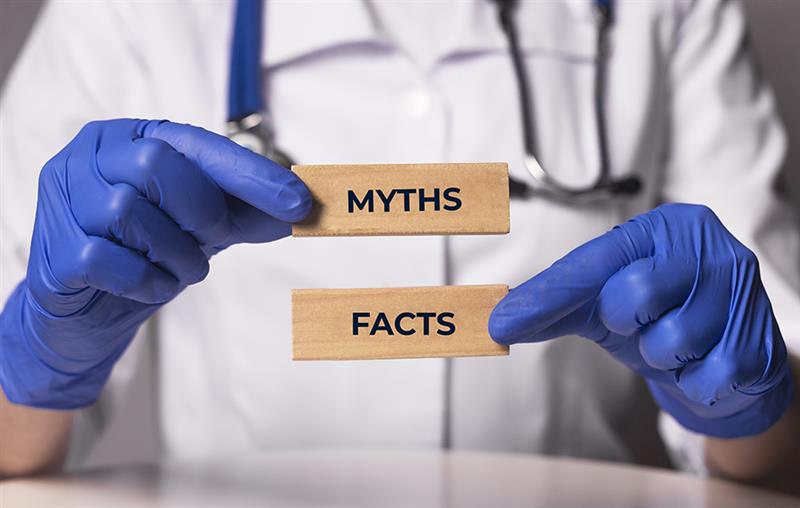 Image-of-an-hcp-doctor-holding-up-myth-vs-facts-cards-about-the-idea-of-paid-medical-surveys-and-their-benefits